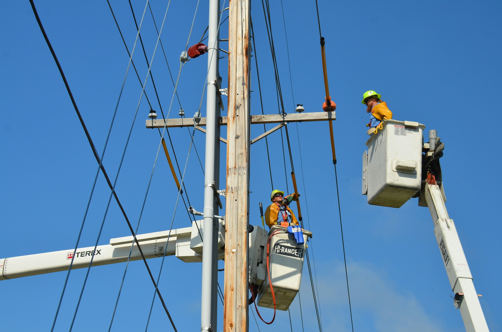 Utility crews repairing storm-damaged power lines